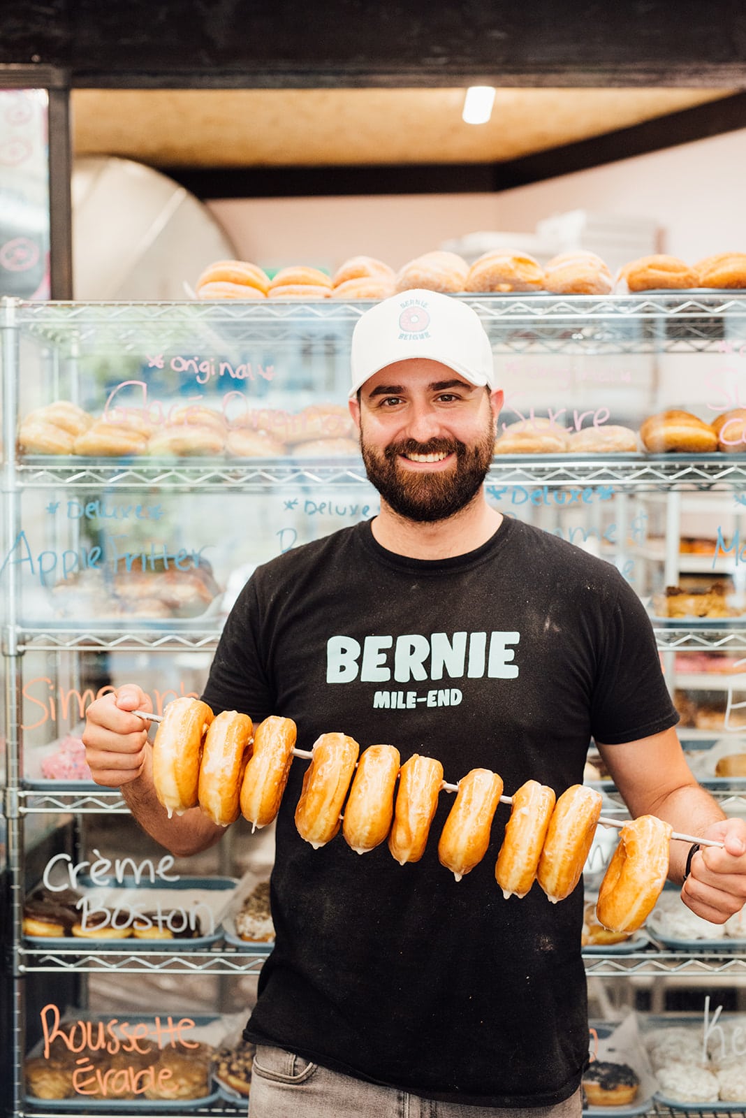 Person holding donuts from Bernie Beigne